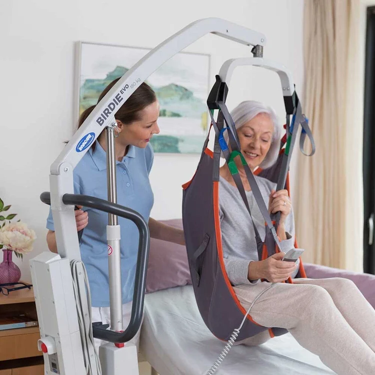 Invacare Birdie Evo folding electric hoist in use